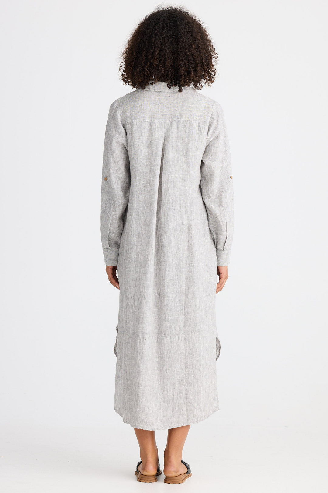 Person wearing a long light gray dress on a white background