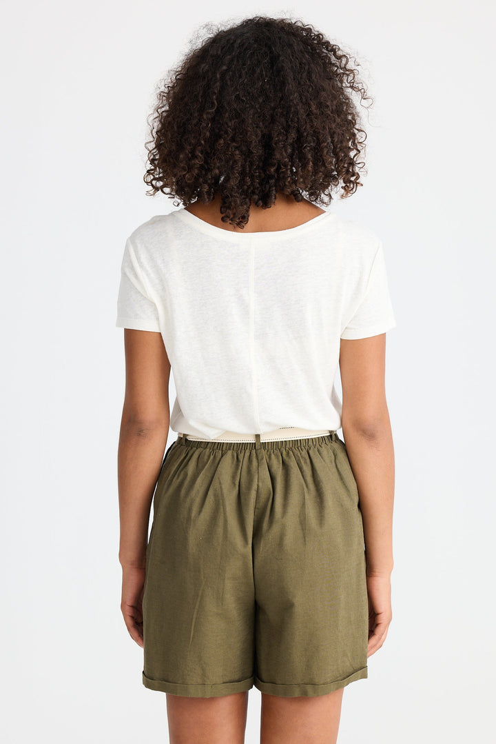 Person wearing a white t-shirt and olive green shorts on a white background