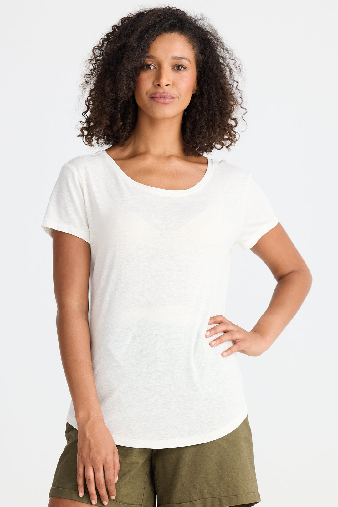 Woman wearing a white t-shirt and green shorts on a white background