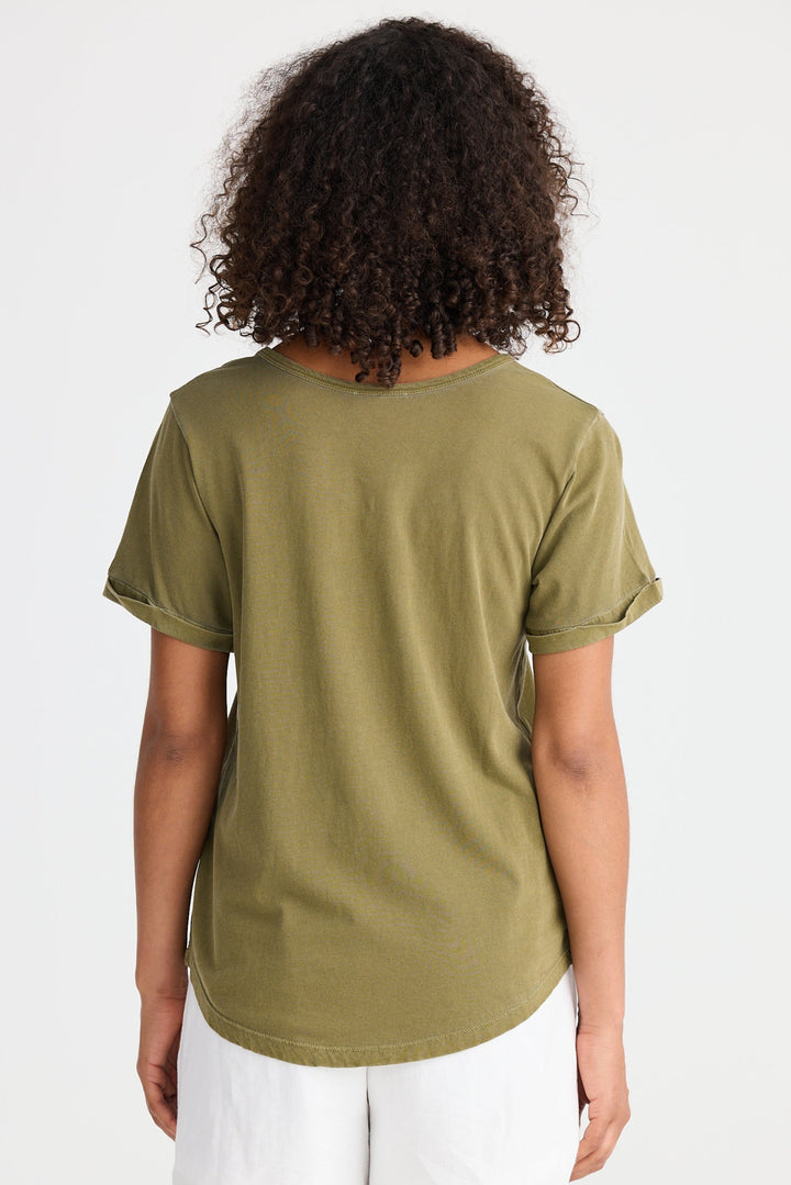 Person wearing an olive green t-shirt and white shorts on a white background