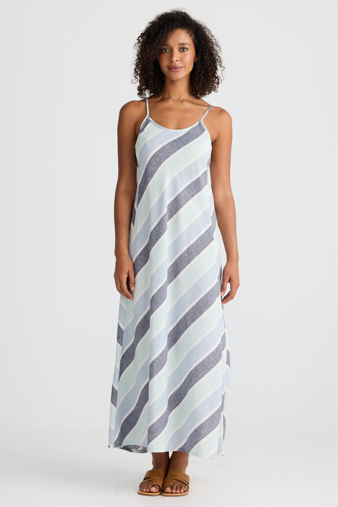 Woman wearing a striped slip dress on a white background