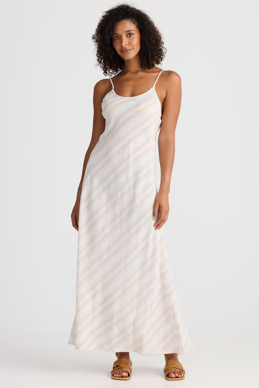 Woman wearing a light dress with a subtle stripe on a white background