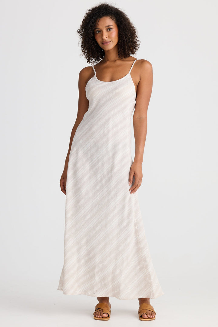Woman wearing a light dress with a subtle stripe on a white background