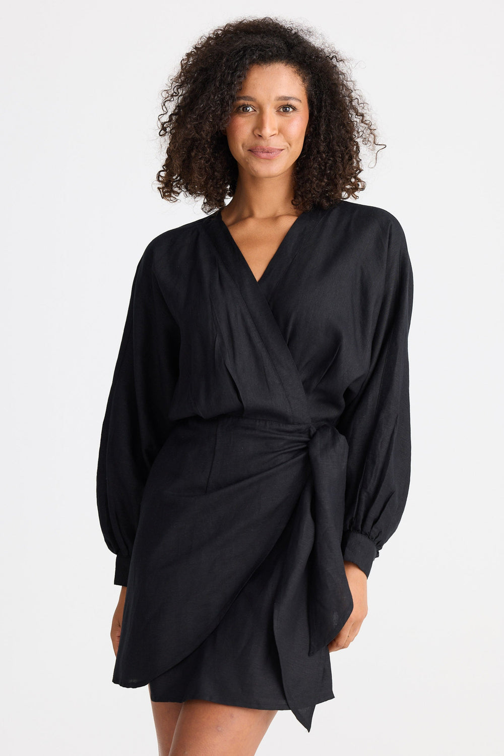 Woman wearing a black wrap dress on a white background