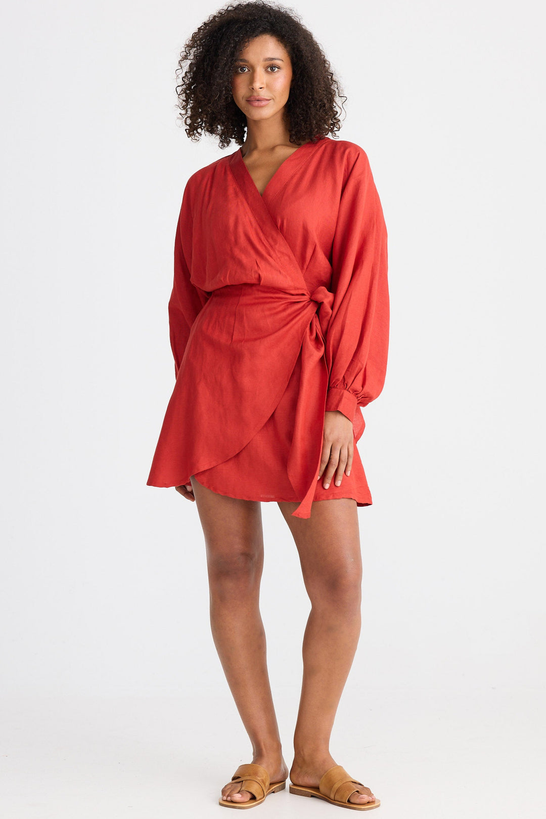 Woman wearing a red wrap dress on a white background