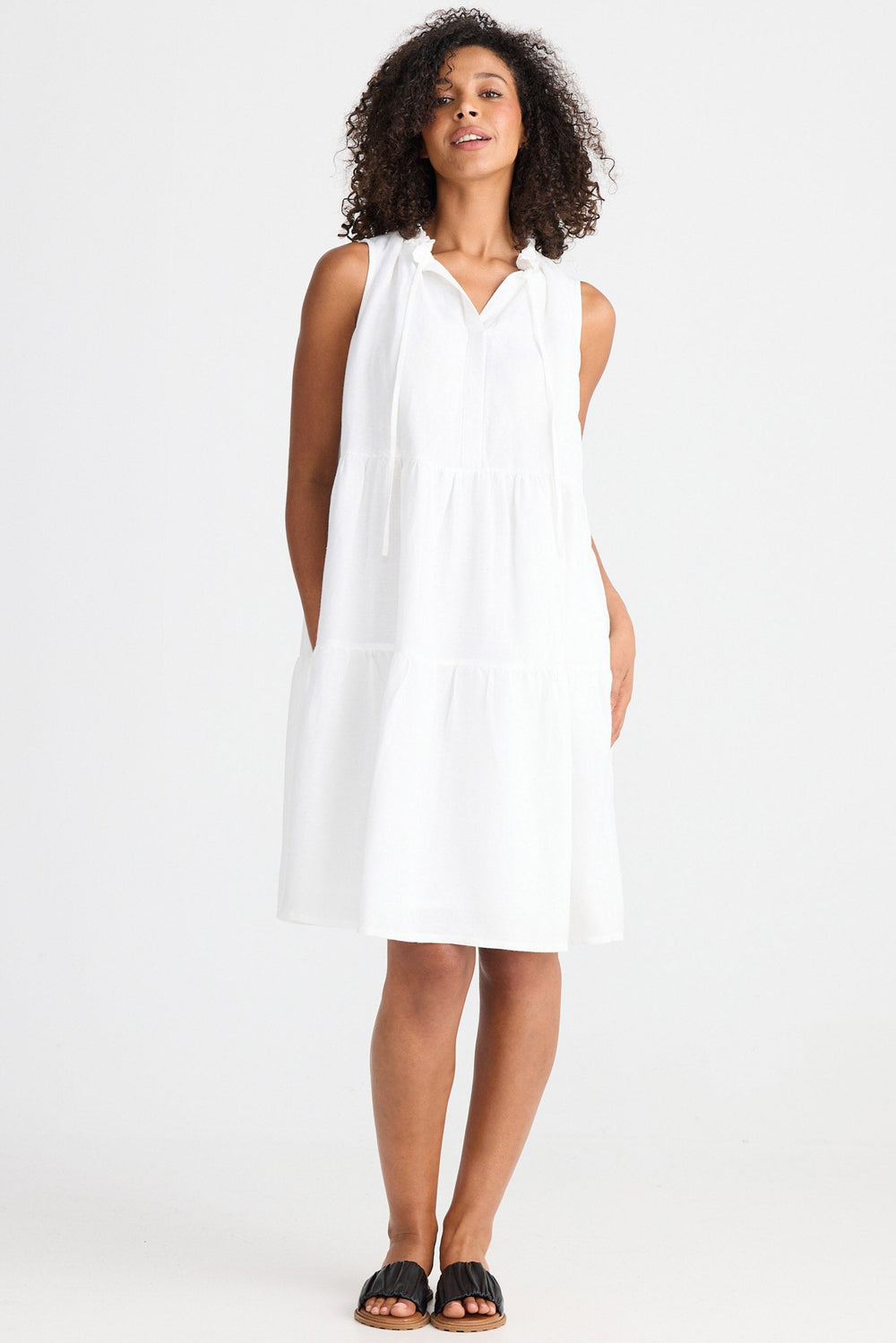 Woman wearing a white dress on a white background