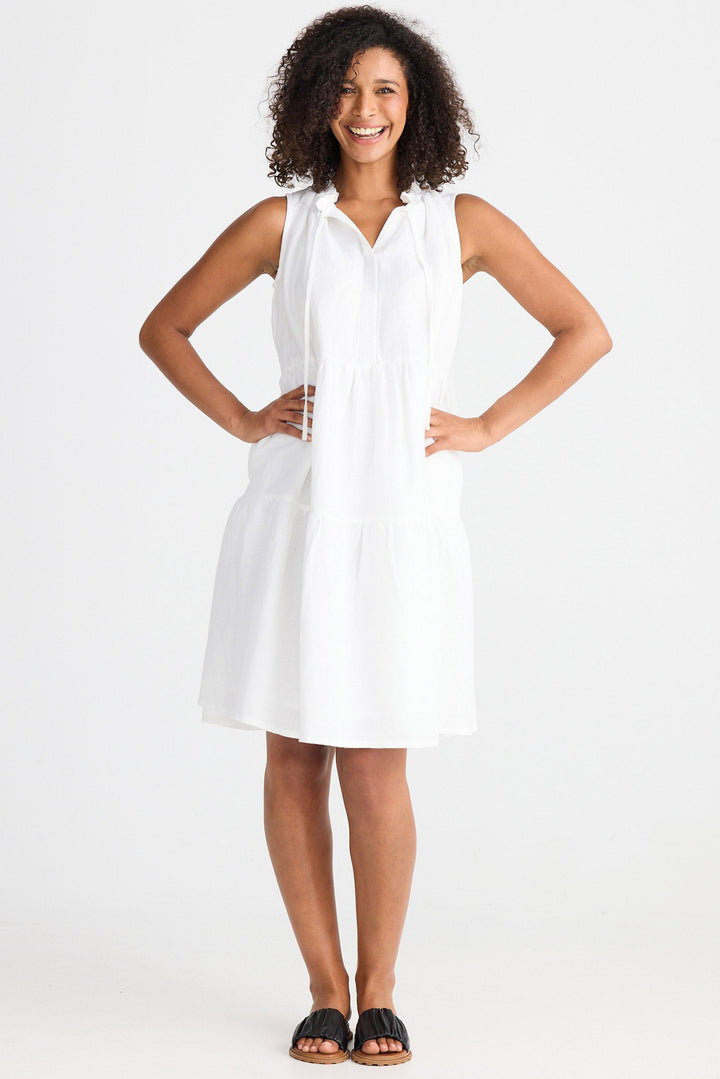 Woman wearing a white sleeveless dress on a white background