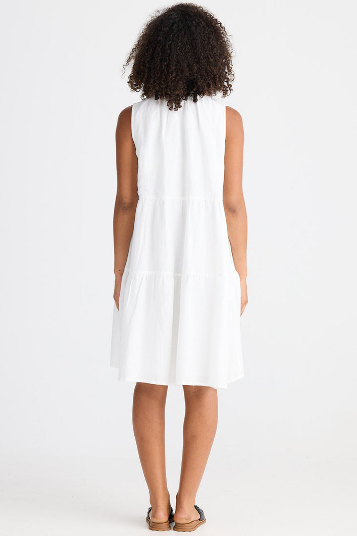 Person wearing a white sleeveless dress on a white background