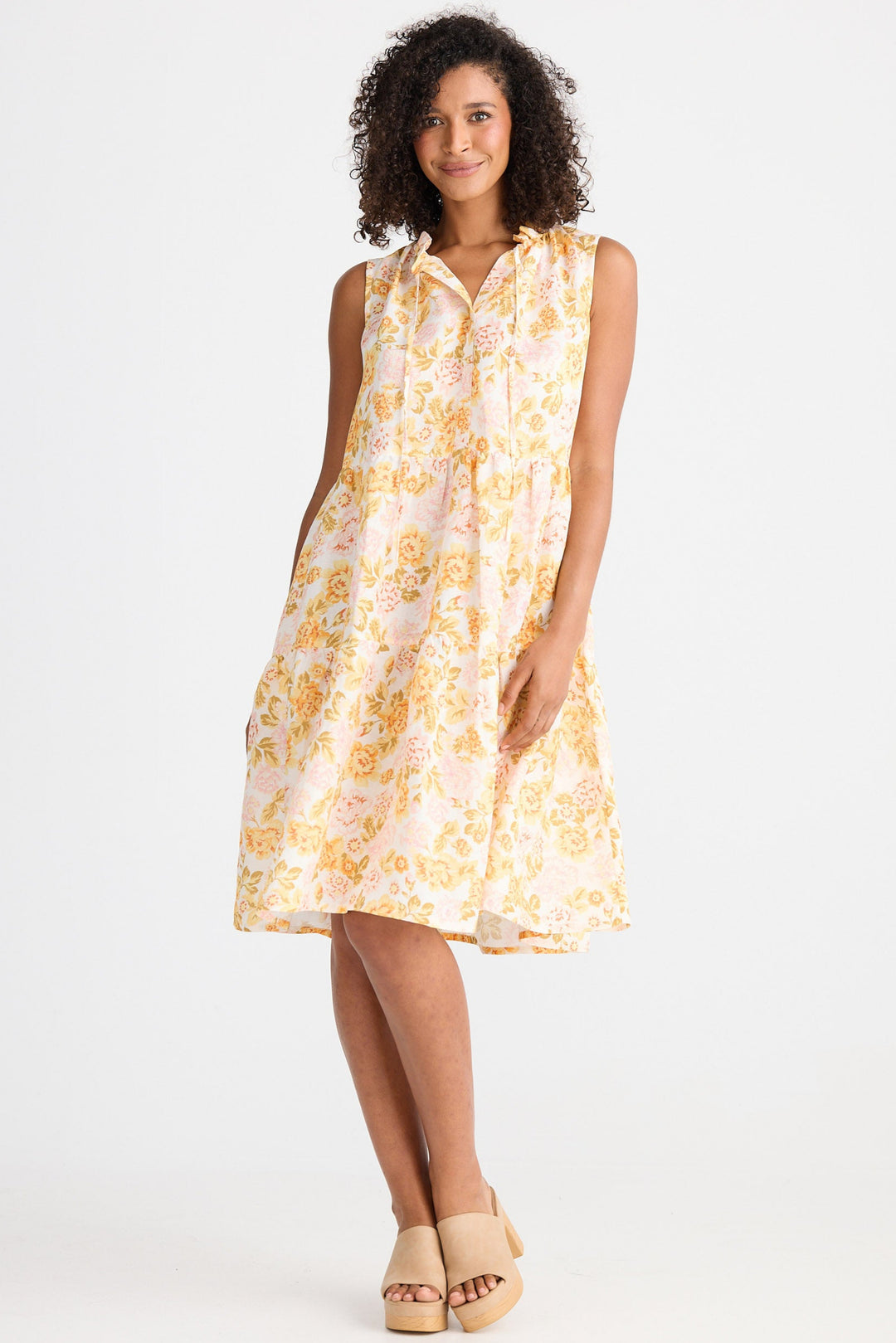 Woman wearing a light floral dress on a white background