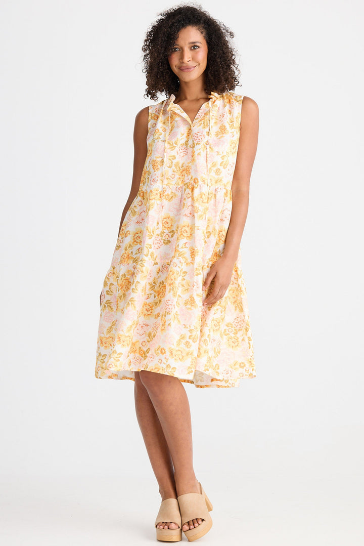 Woman wearing a light floral dress on a white background