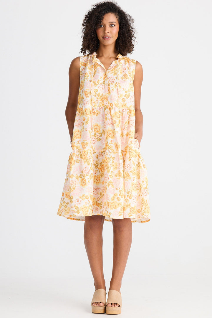 Woman wearing a light floral dress on a white background
