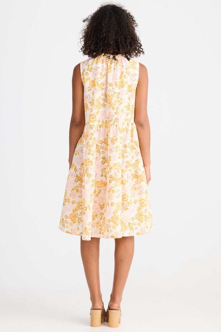 Woman wearing a light floral dress on a white background