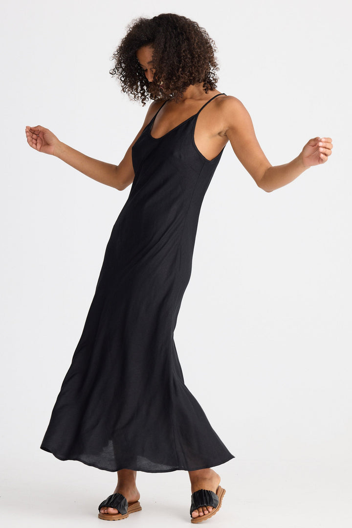 Woman wearing a black dress against a white background