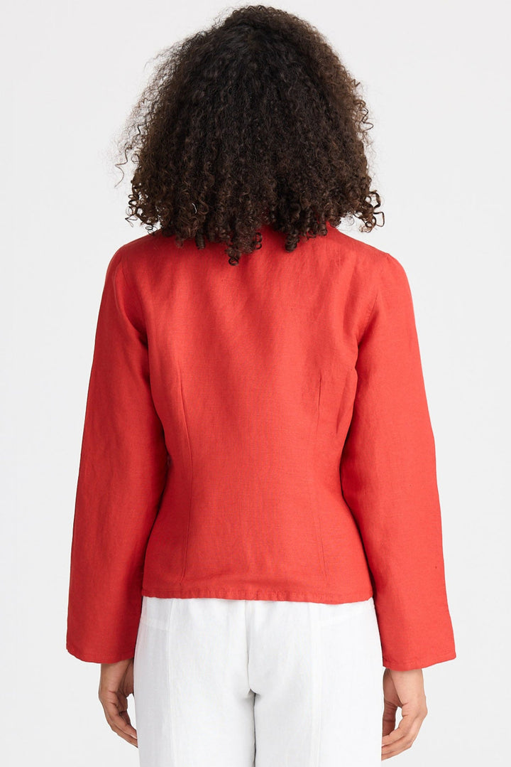 Person wearing a red jacket and white pants on a white background