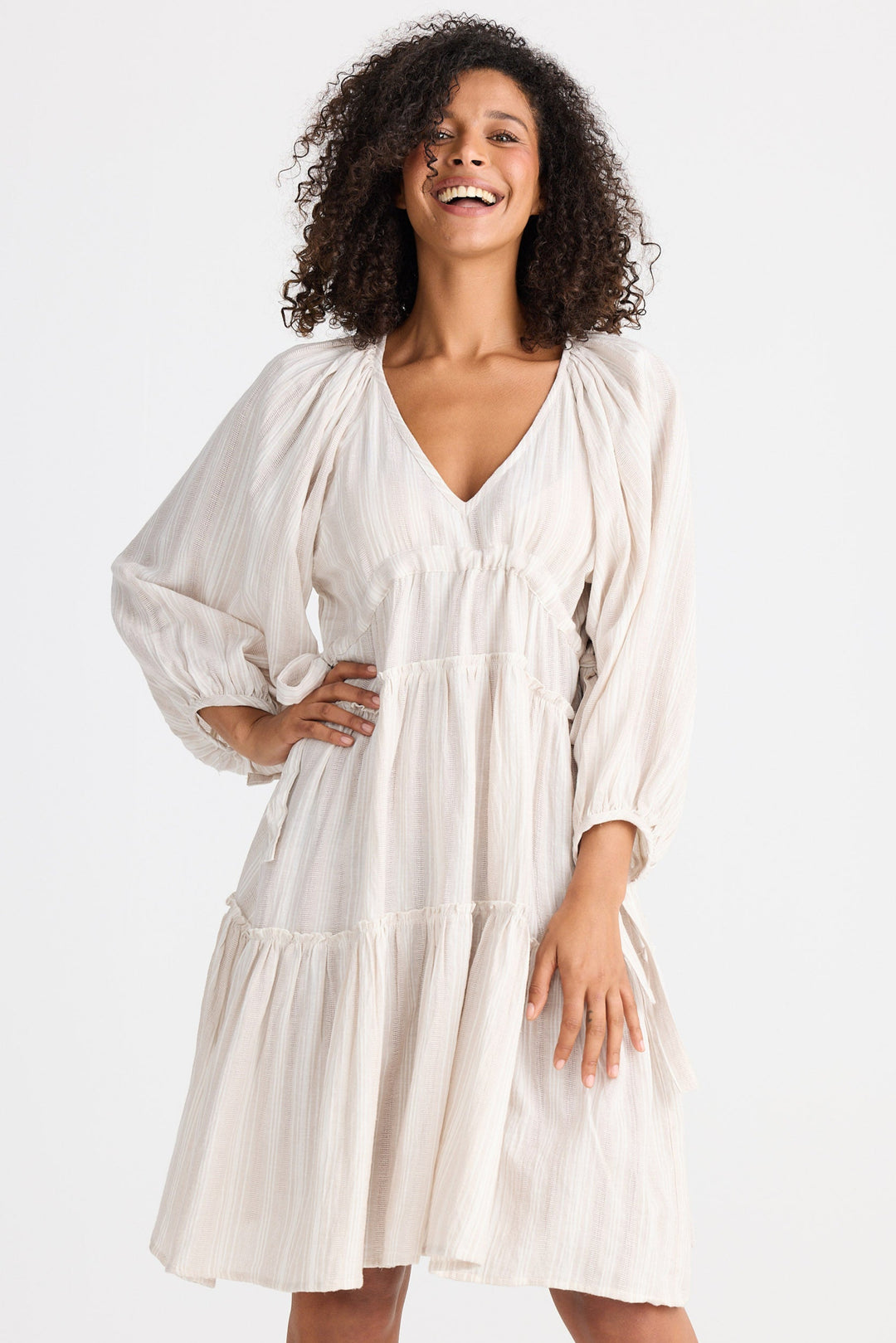 Woman wearing a light dress on a white background