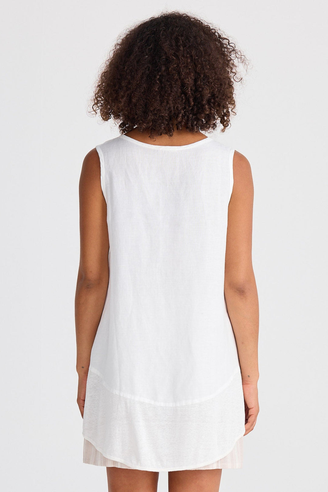 Person wearing a white dress on a plain background