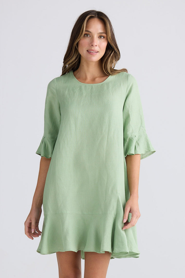 Woman wearing a light green dress on a white background