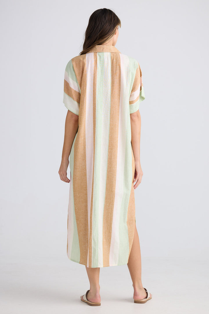 Woman wearing a striped dress with a plain background