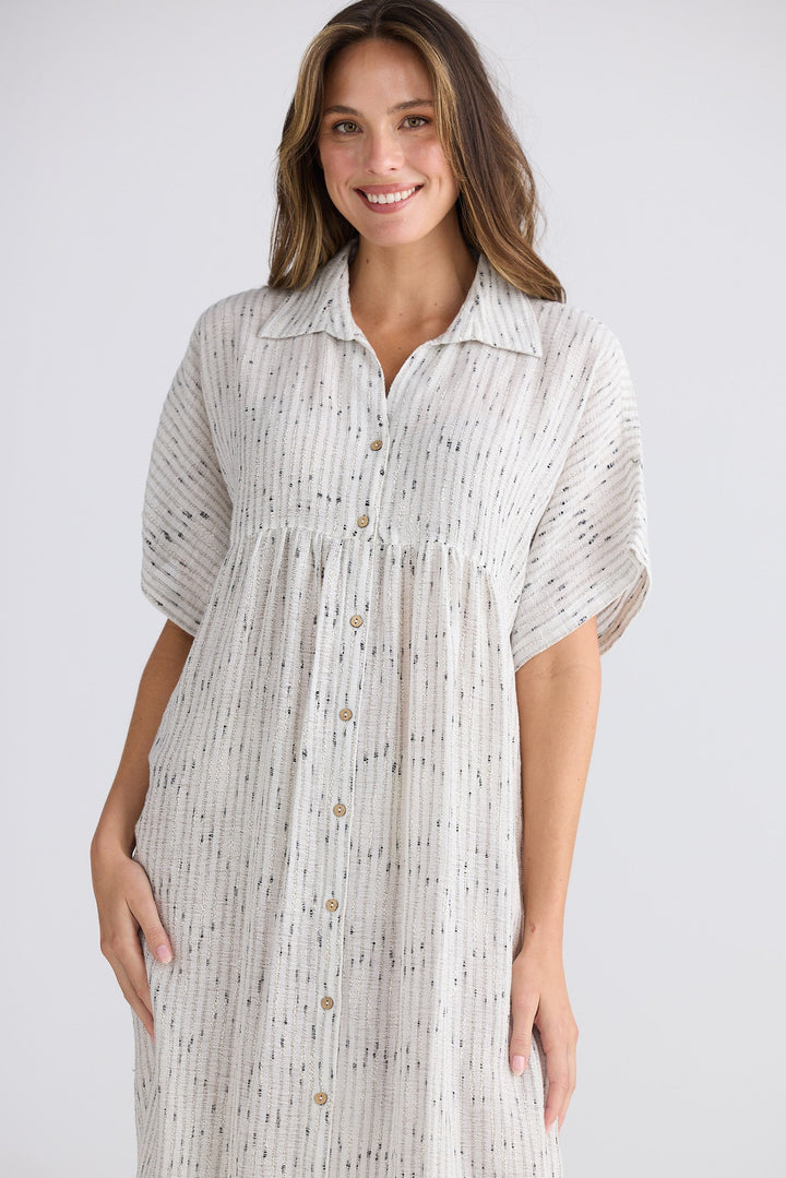 Woman wearing a patterned dress on a white background