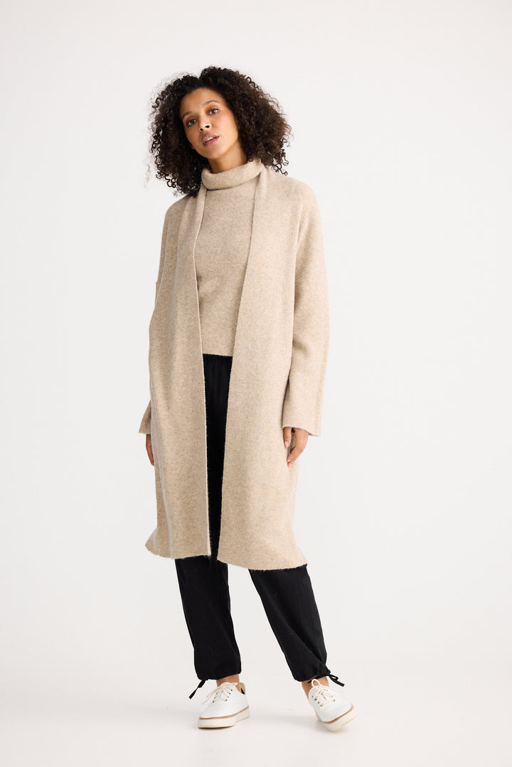 Model wearing oatmeal Lucerne Cardi, back view on white background