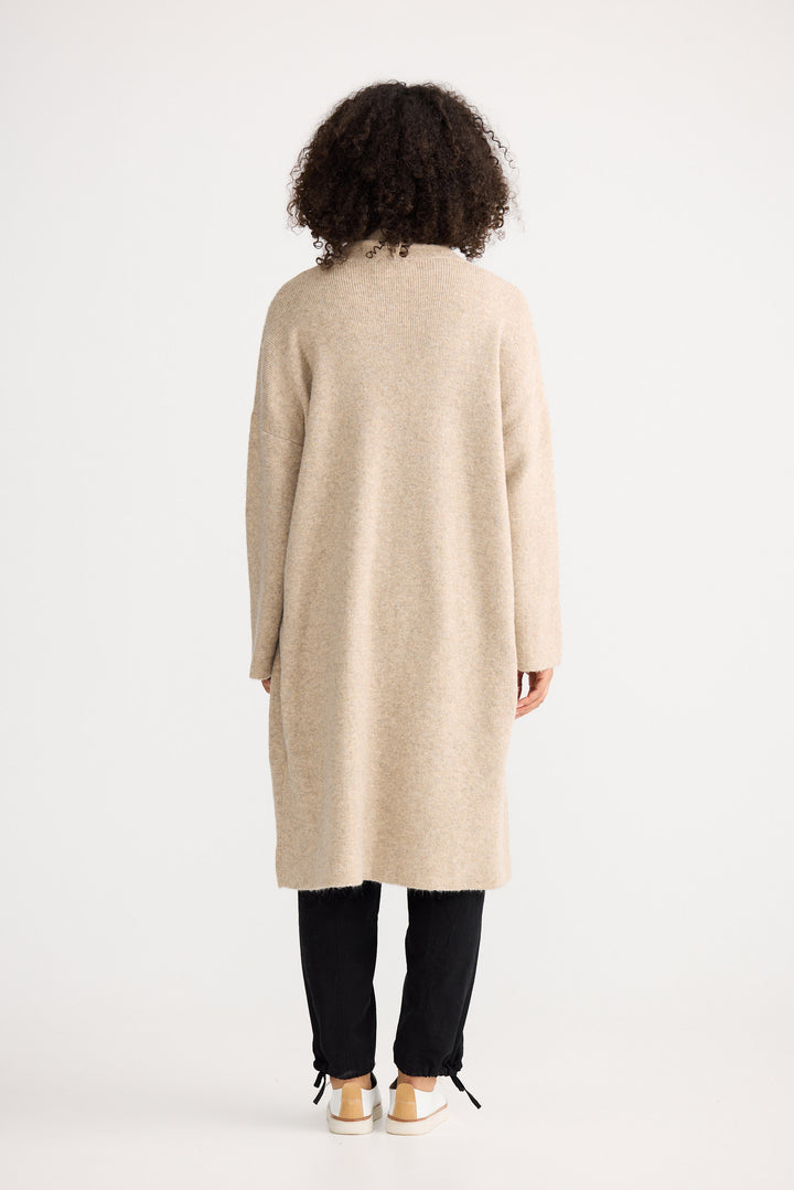 Model wearing oatmeal Lucerne Cardi, angled front view on white background