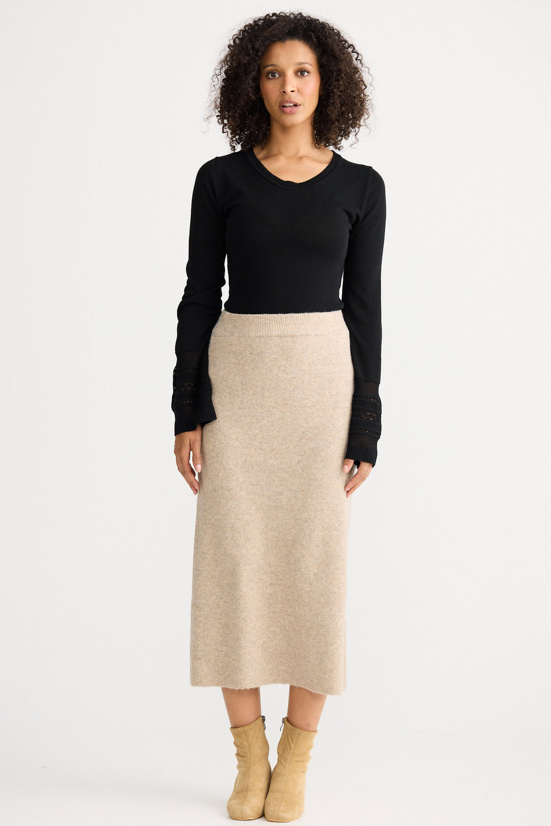 Model wearing oatmeal Lucerne Knit Skirt, angled front view on white background