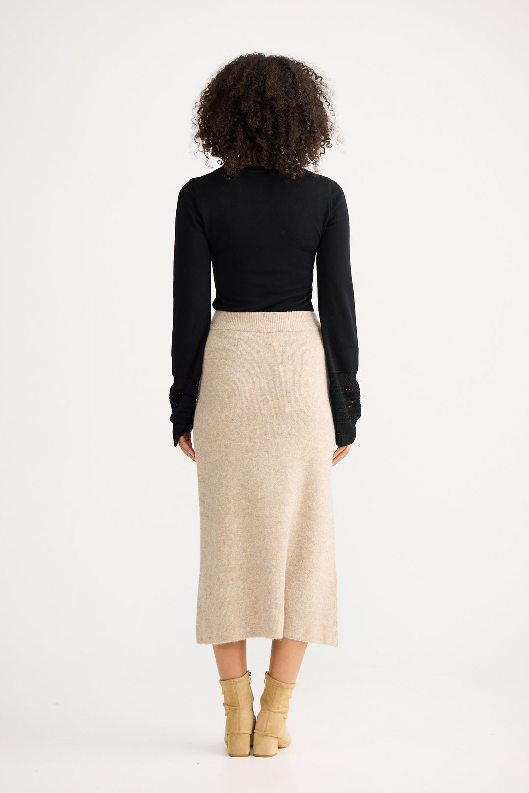 Model wearing oatmeal Lucerne Knit Skirt, back view on white background