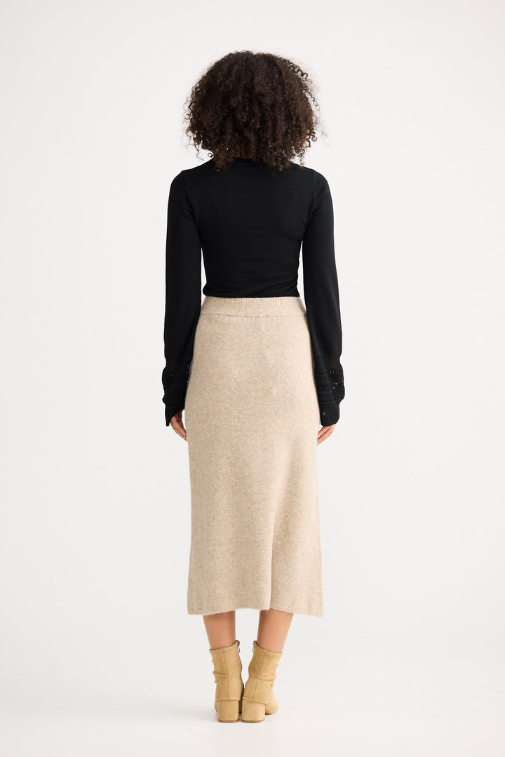 Model wearing oatmeal Lucerne Knit Skirt, back view on white background
