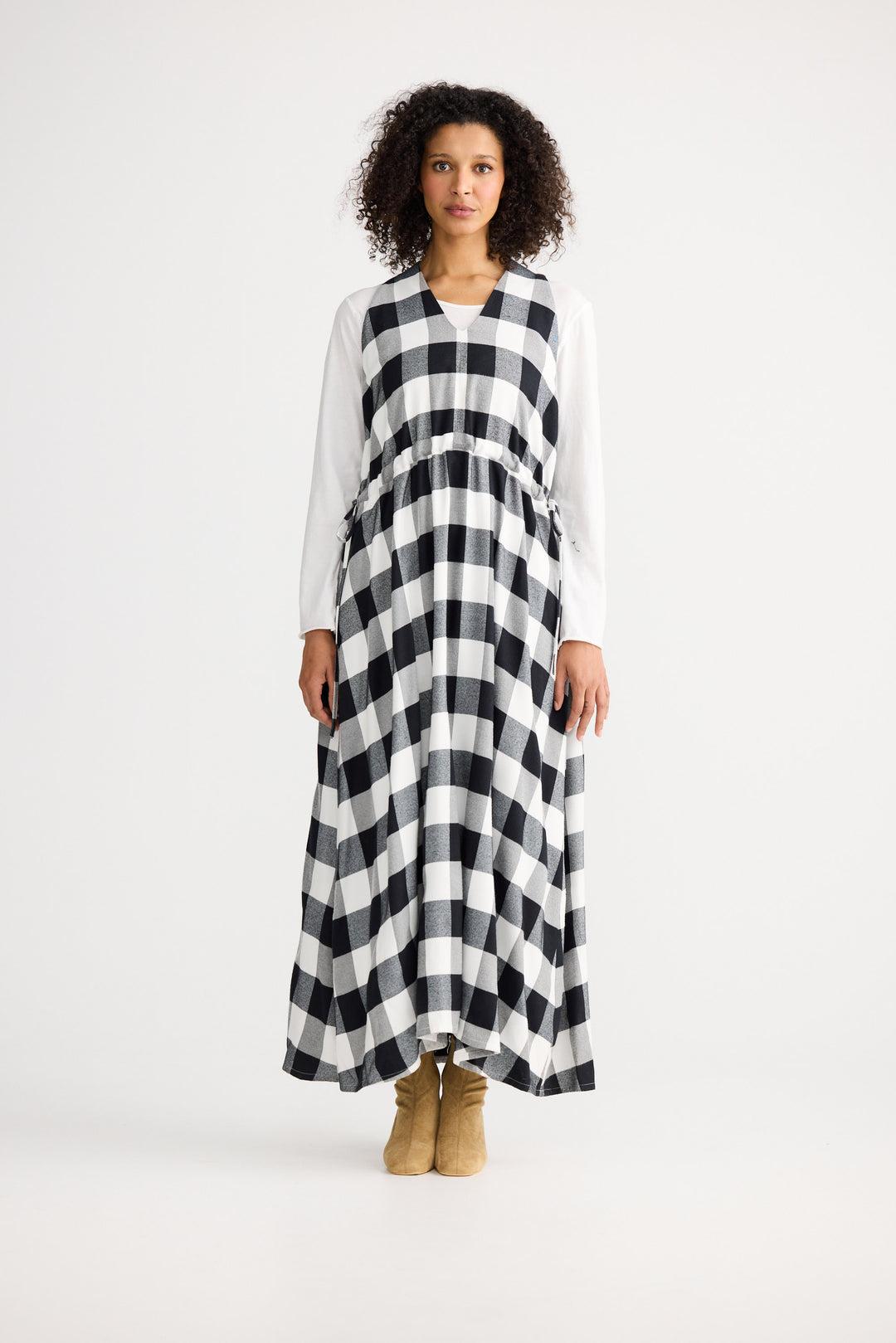 Woman wearing a black and white checkered dress on a white background
