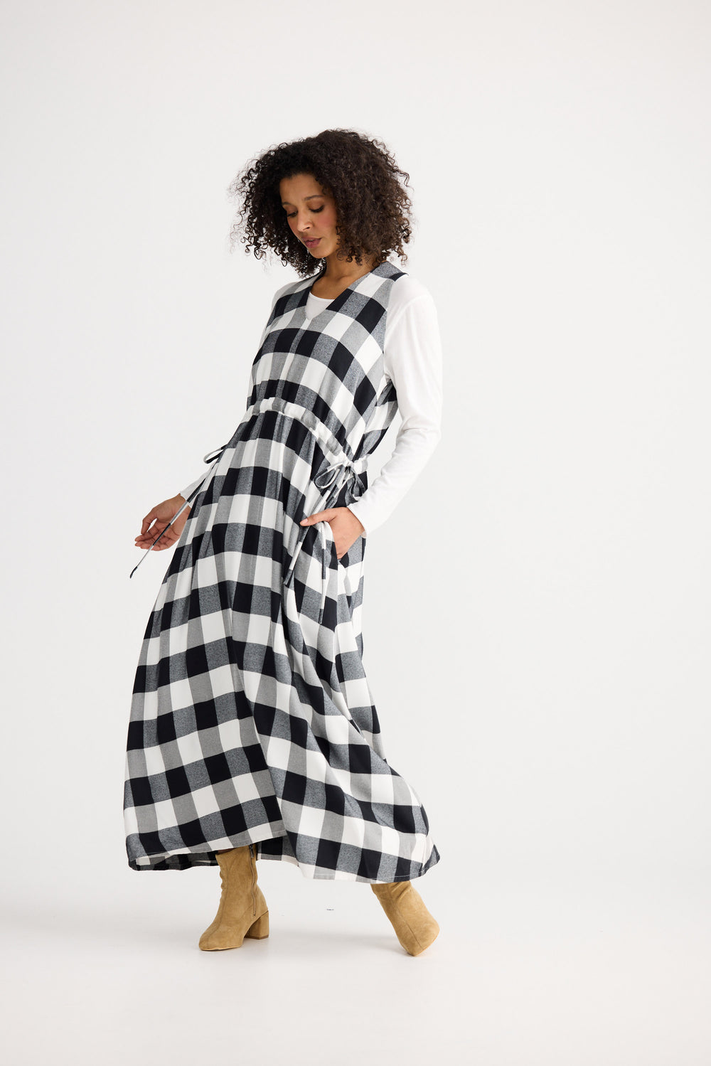 Woman wearing a black and white checkered dress on a white background