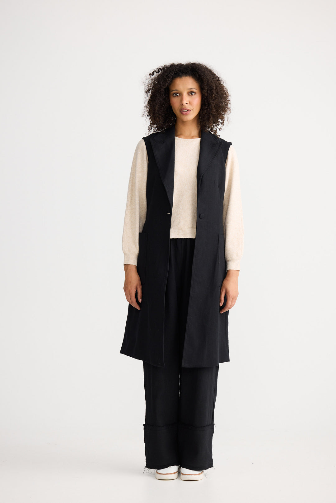 Model wearing black Noa Vest, angled front view on white background