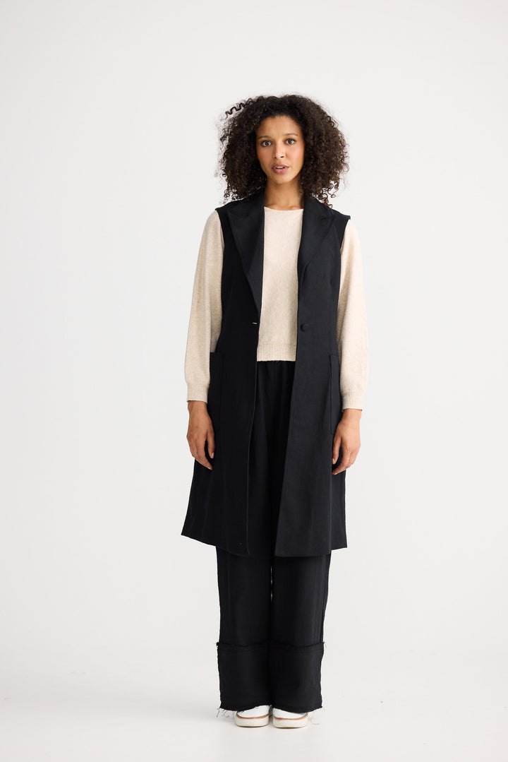 Model wearing black Noa Vest, angled front view on white background