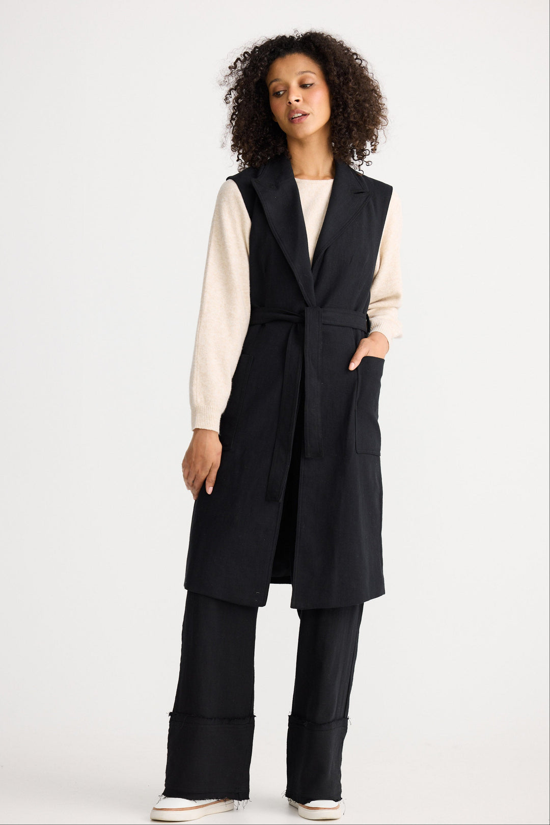 Model wearing black Noa Vest, front view on white background