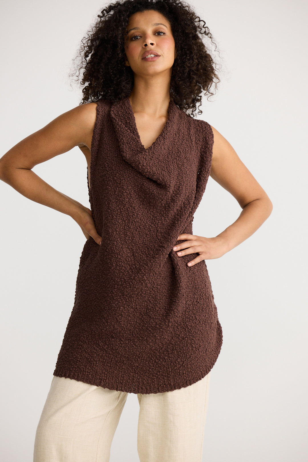 Model wearing chocolate Tova Knit Tank, side view on white background
