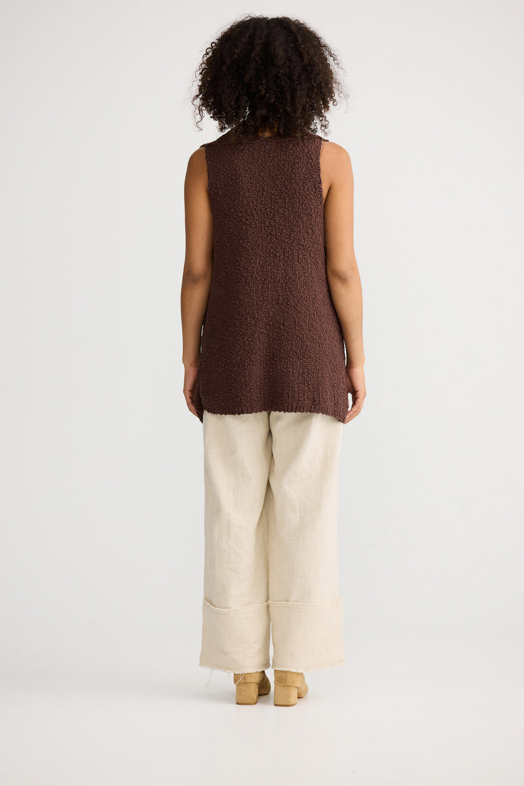 Model wearing chocolate Tova Knit Tank, back view on white background