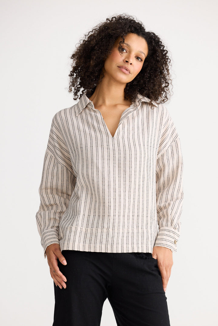 Model wearing natural stitch Wander Long Sleeve Top, front view on white background