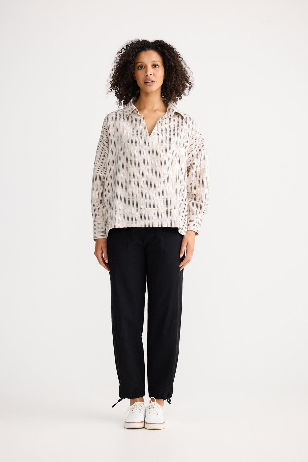 Model wearing natural stitch Wander Long Sleeve Top, detail view on white background