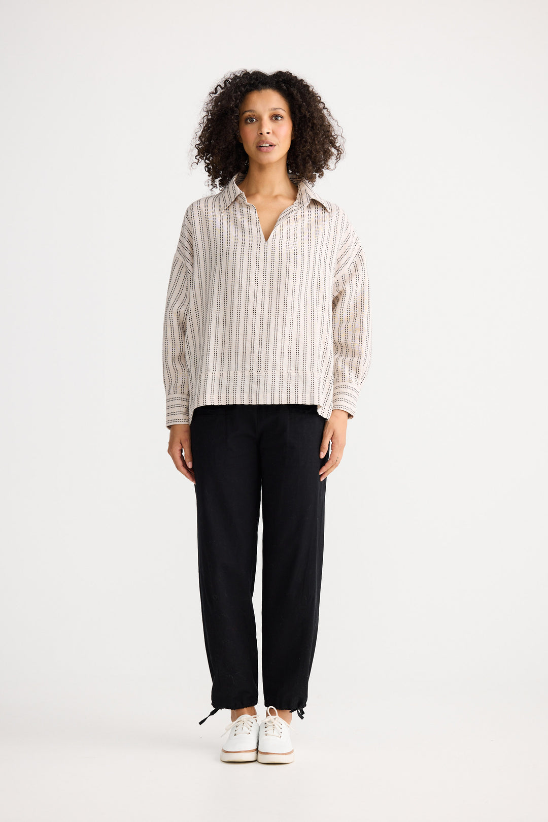 Model wearing natural stitch Wander Long Sleeve Top, detail view on white background