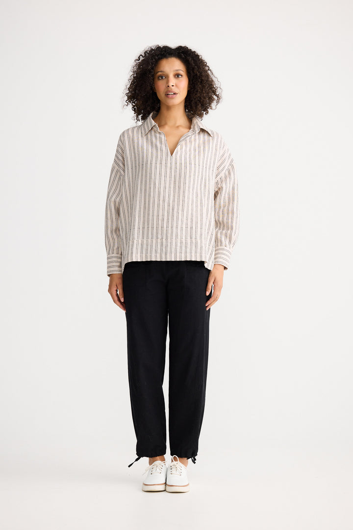 Model wearing natural stitch Wander Long Sleeve Top, detail view on white background
