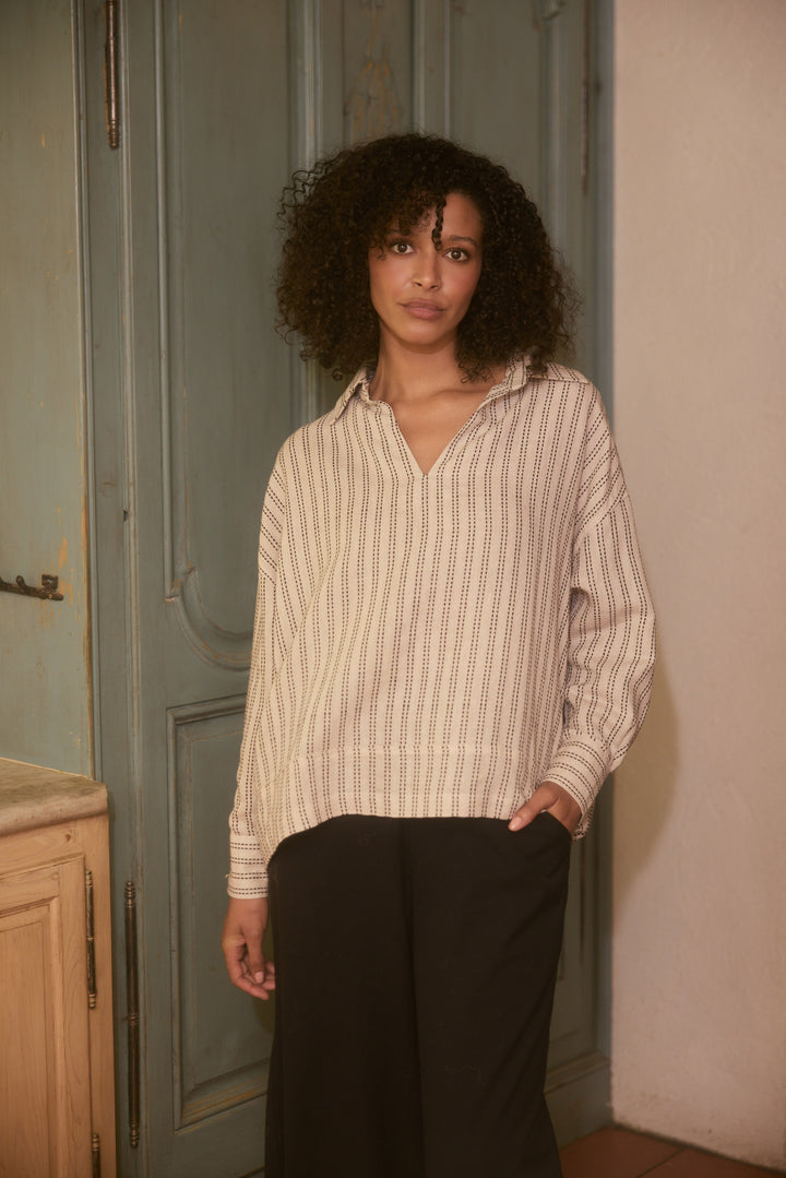 Model wearing natural stitch Wander Long Sleeve Top, lifestyle close-up view