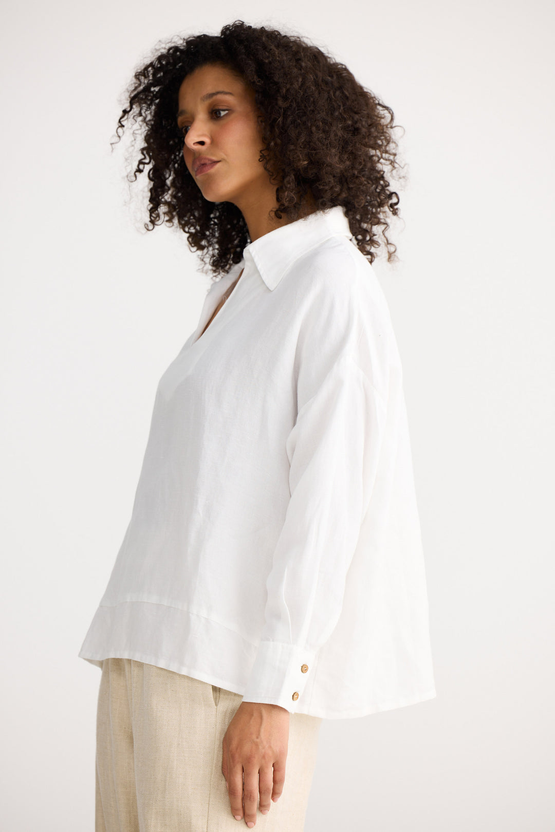 Woman wearing a white blouse with a plain background