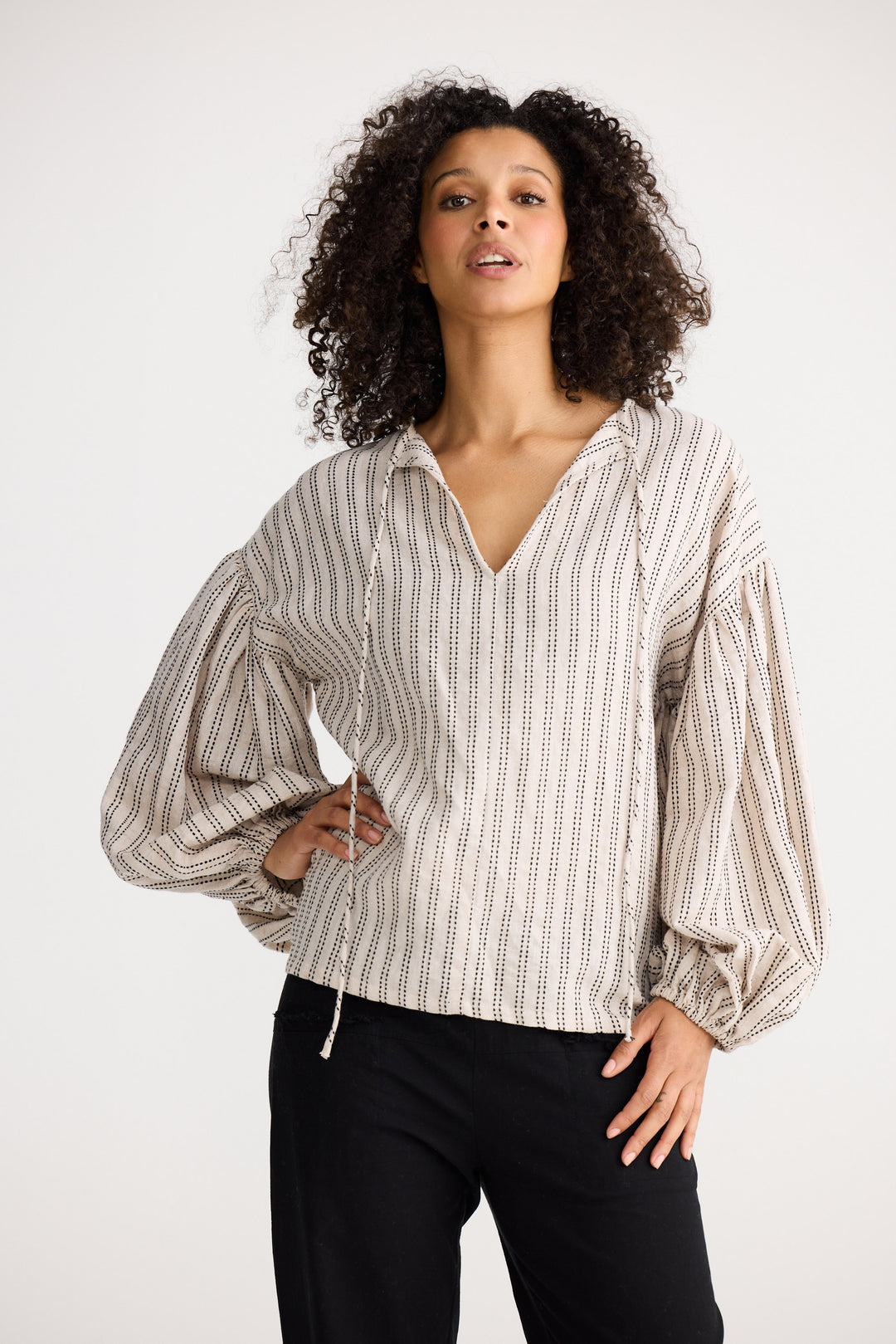 Model wearing natural stitch Copenhagen Top, side view on white background