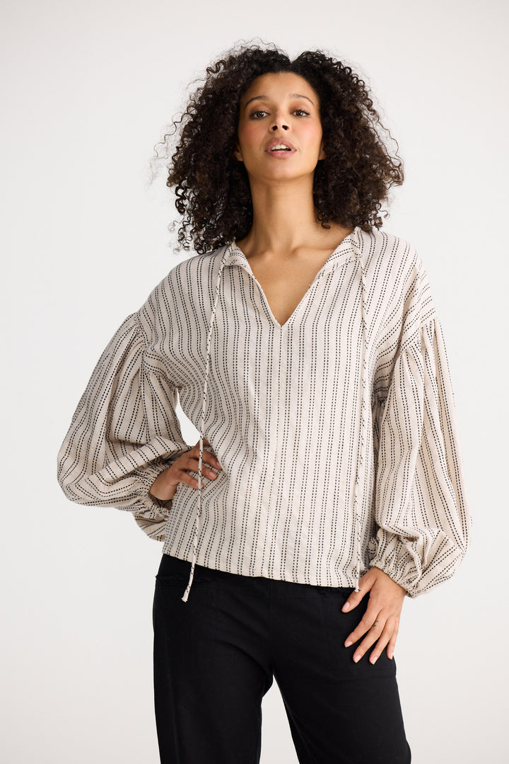 Model wearing natural stitch Copenhagen Top, side view on white background