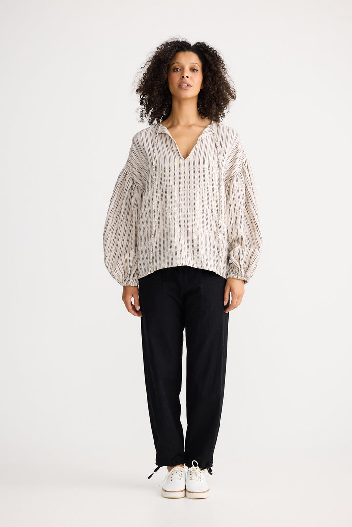 Model wearing natural stitch Copenhagen Top, angled front view on white background