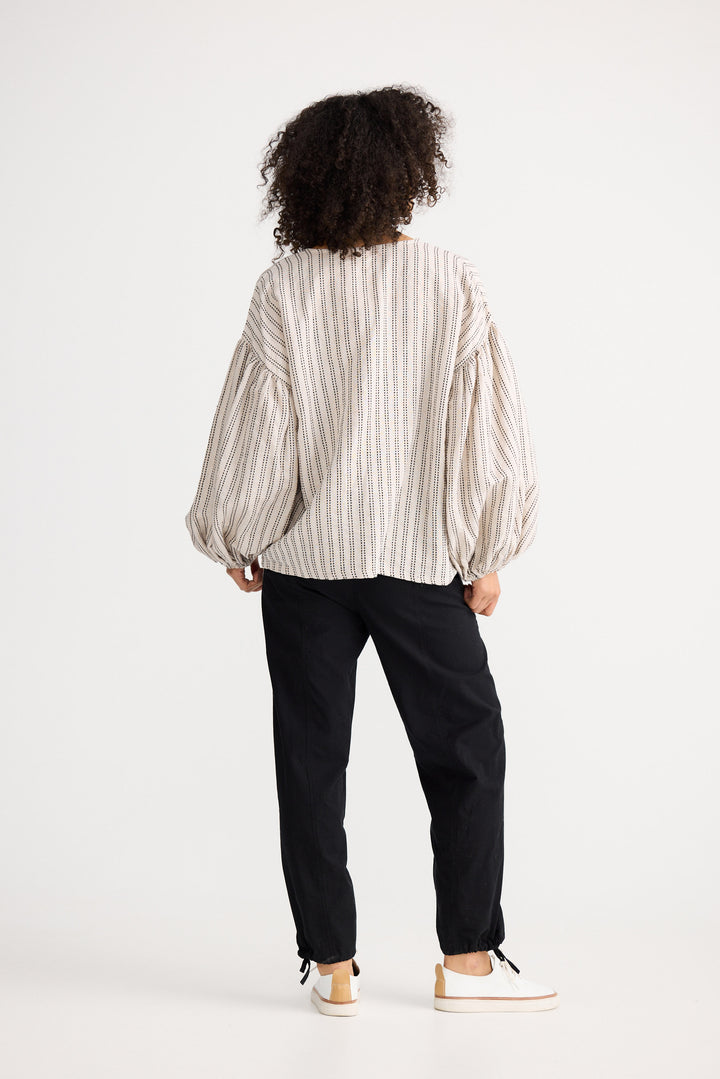 Model wearing natural stitch Copenhagen Top, back view on white background