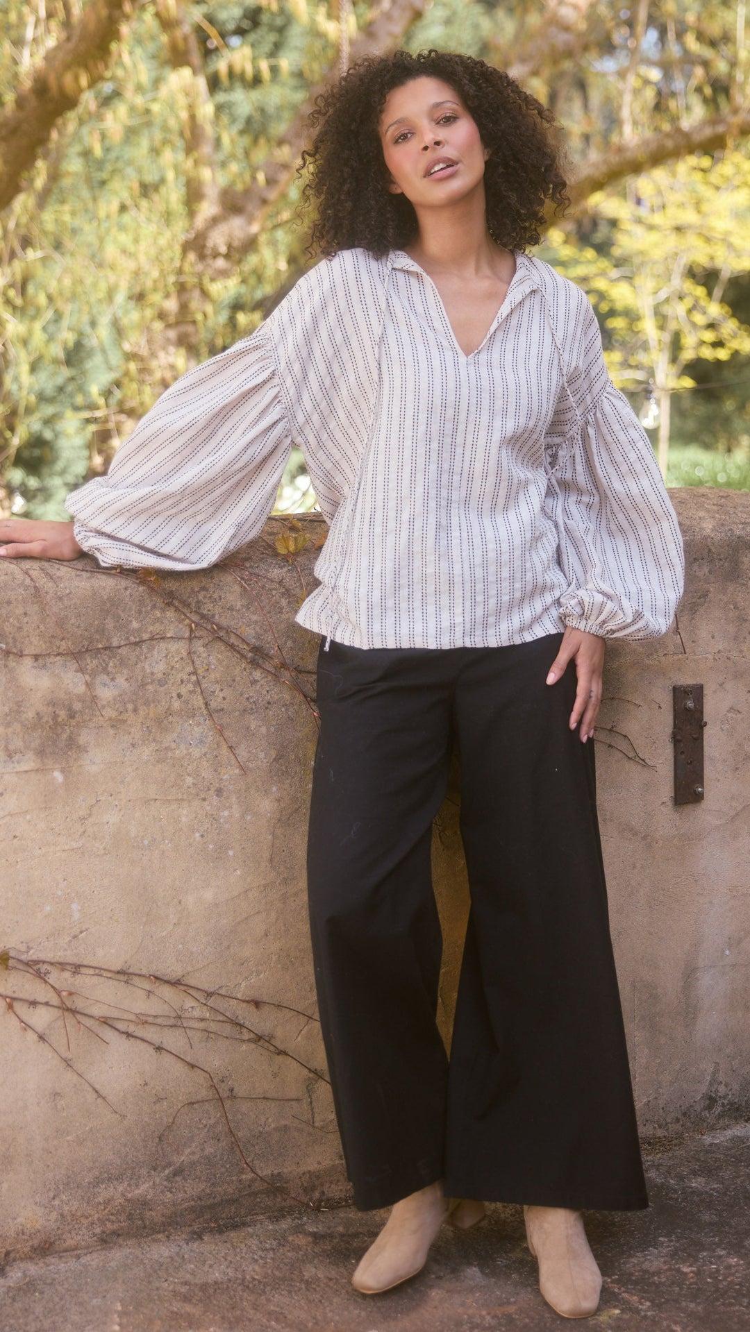 Model wearing natural stitch Copenhagen Top, lifestyle close-up view