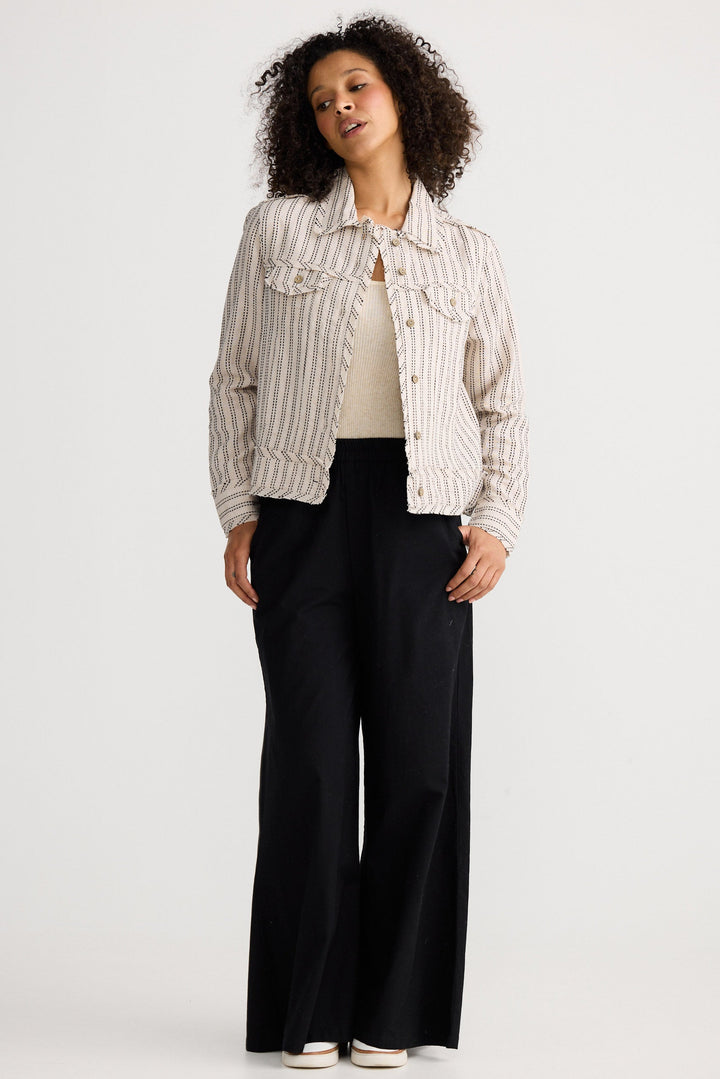 Model wearing natural stitch Monza Jacket, angled front view on white background