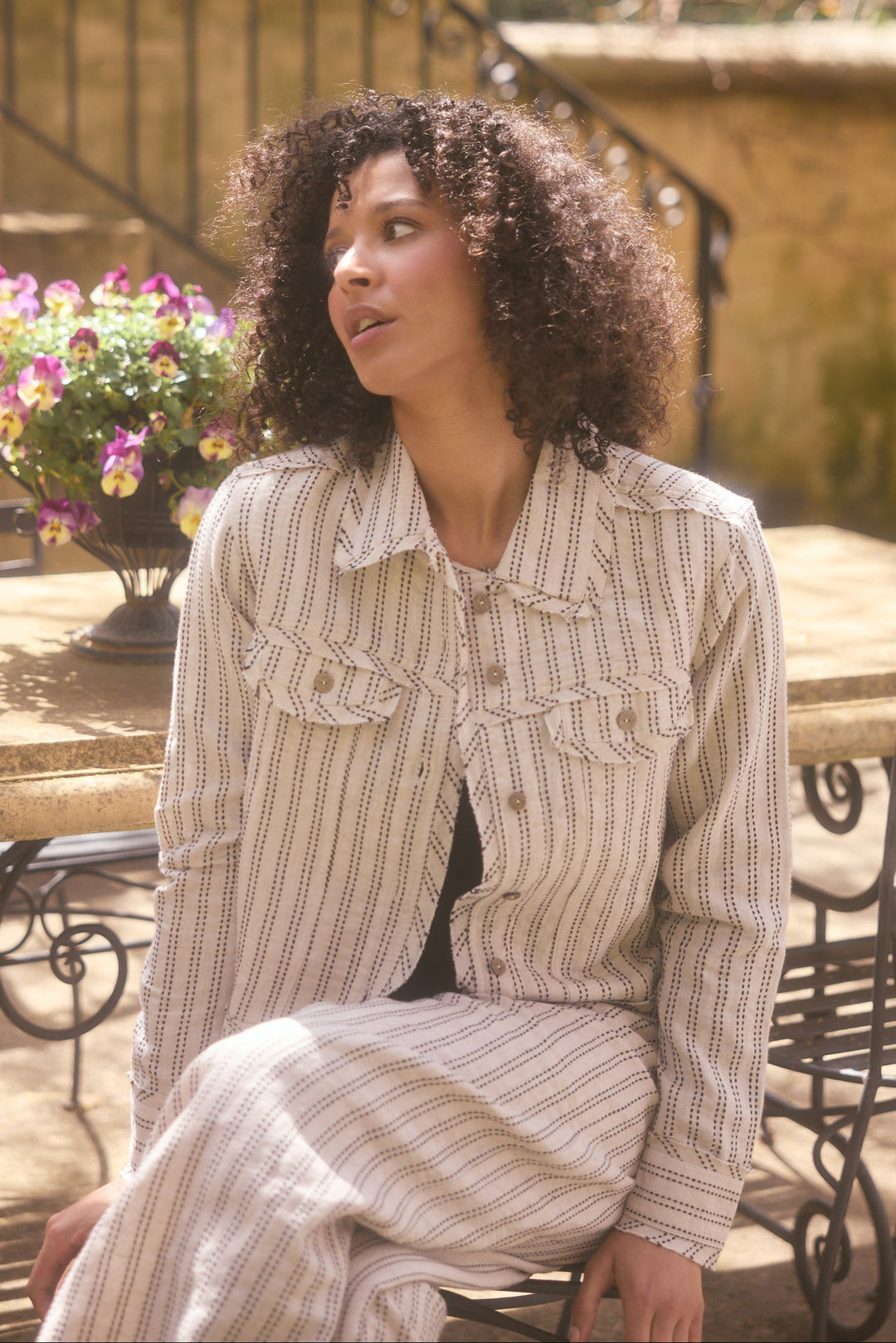 Model wearing natural stitch Monza Jacket, lifestyle close-up view
