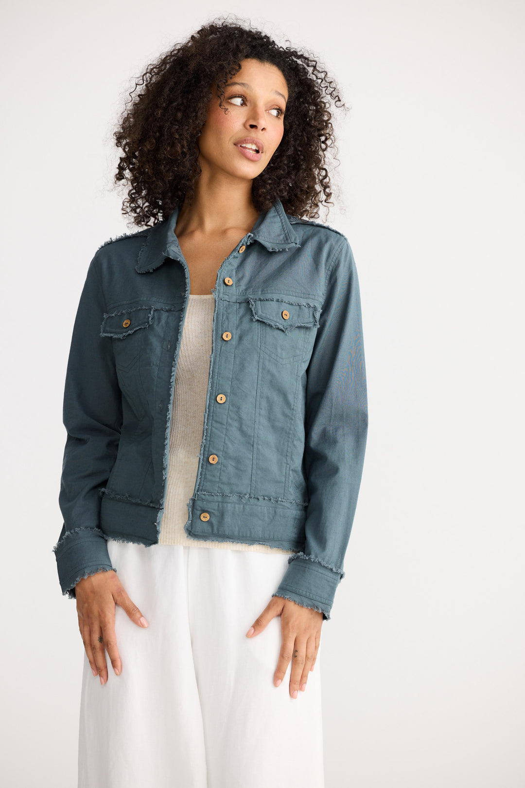 Woman wearing a denim jacket on a white background