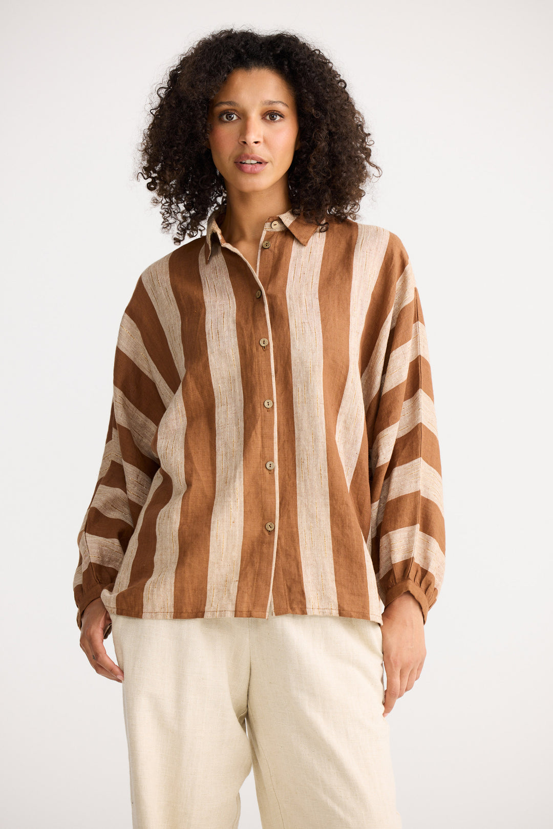 Model wearing sienna stripe Milano Shirt, side view on white background